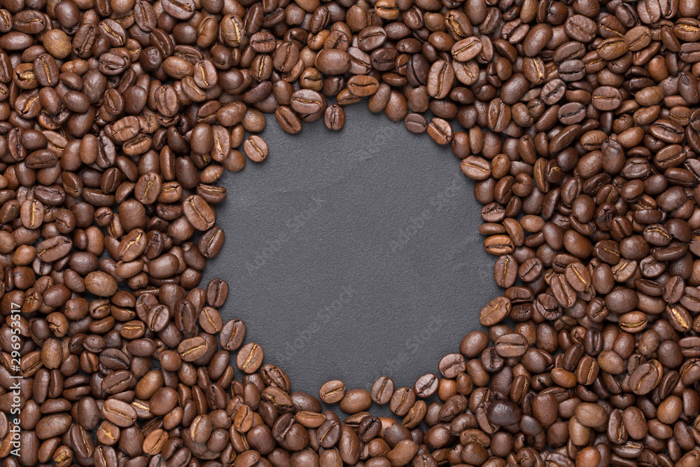 Roasted coffee beans round frame background on black with copy space Roasted coffee beans round frame background on black with copy space