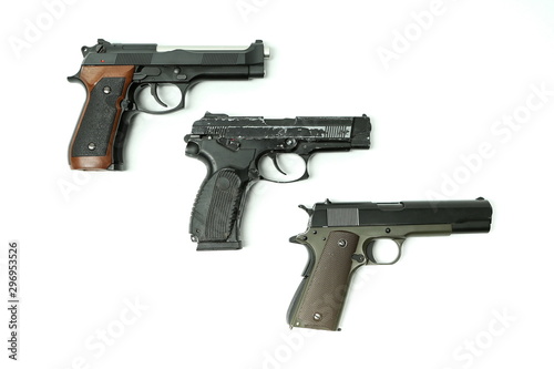 three pistols on a white background with copy space
