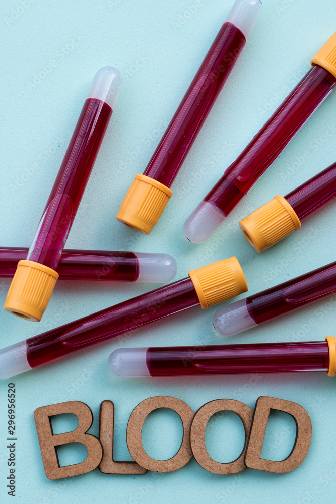 vacuum tubes with blood and the word blood written vacuum tubes with blood and the word blood written