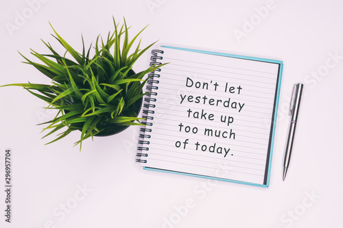 Don't let yesterday take up too much of today - Inspiration quotes on note pad. photo