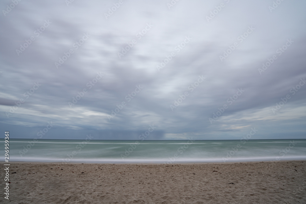 Long exposure beach scene motion blur in the waves Long exposure beach scene motion blur in the waves