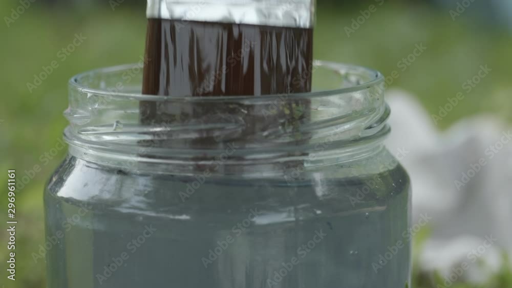 Dipping a brush in a bottle of water in super slow motion. Dipping a brush in a bottle of water in super slow motion.