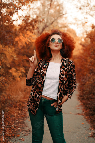 Woman with afro walks in the Park in autumn.