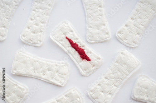  sanitary pad with red sparkles on a white background. Menstruation concept