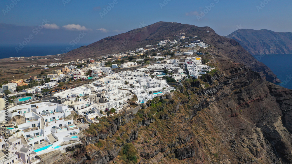 Aerial panoramic photo of iconic village of Oia built on a cliff in famous island of Santorini, Cyclades, Greece