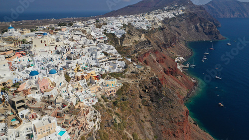 Aerial drone photo of traditional and picturesque village of Oia in volcanic island of Santorini, Cyclades, Greece © aerial-drone