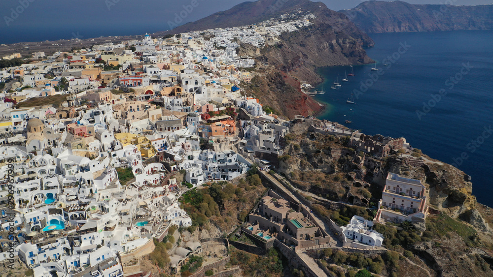Aerial drone photo of traditional and picturesque village of Oia in volcanic island of Santorini, Cyclades, Greece