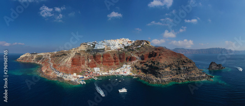 Aerial drone panoramic photo of traditional and picturesque village of Oia in volcanic island of Santorini, Cyclades, Greece