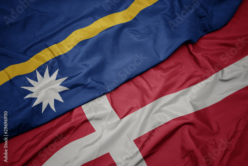 waving colorful flag of denmark and national flag of Nauru .