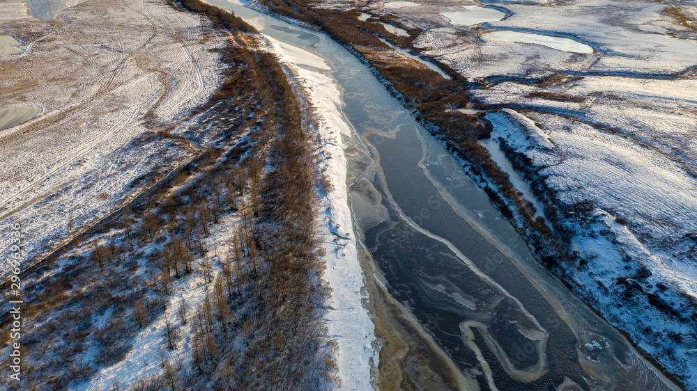 Winter Landscape of the forest-tundra, river bank, bird's eye view.Arctic Circle, tundra. Beautiful landscape of tundra from a helicopter.