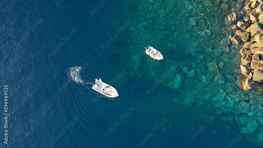Aerial top down photo of fishing boat in small port of Ammoudi, Santorini island, Cyclades, Greece Aerial top down photo of fishing boat in small port of Ammoudi, Santorini island, Cyclades, Greece