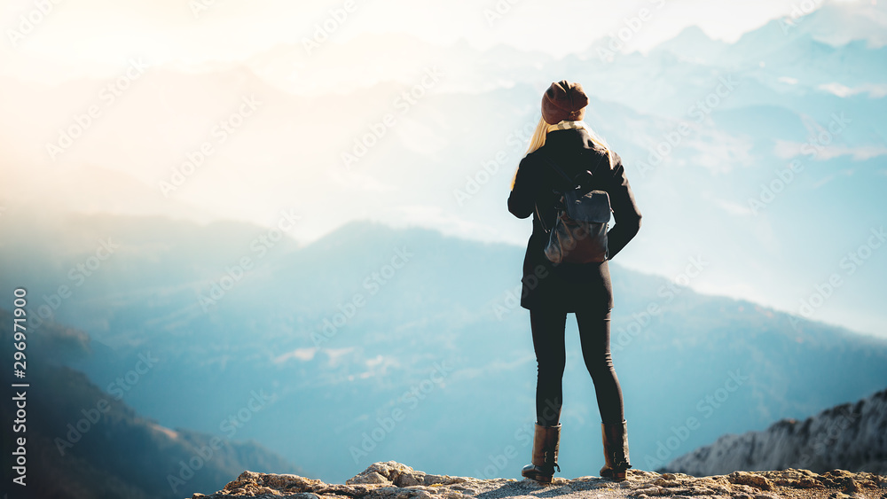 Travel tourism mountains holiday photo - Girl with backpack walking and hiking on Alps - obrazy, fototapety, plakaty 