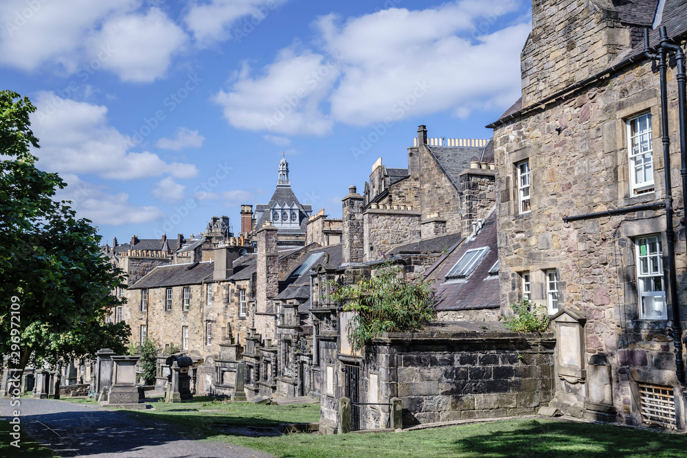 A view of Greyfriars Kirkyard, Edinburgh, Scotland, UK.  The Graves of this Famous Cemetery are frequently Hard Up Against the Surrounding Properties.