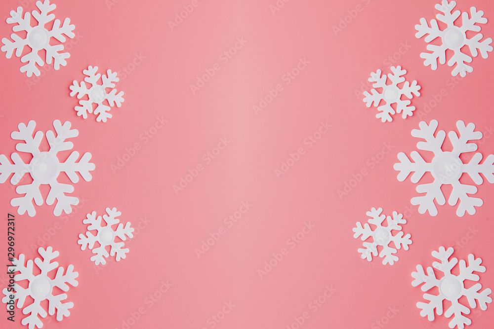 Winter pattern made of snowflakes and on pink background. Christmas concept. Flat lay. Copy space for your text Winter pattern made of snowflakes and on pink background. Christmas concept. Flat lay. Copy space for your text