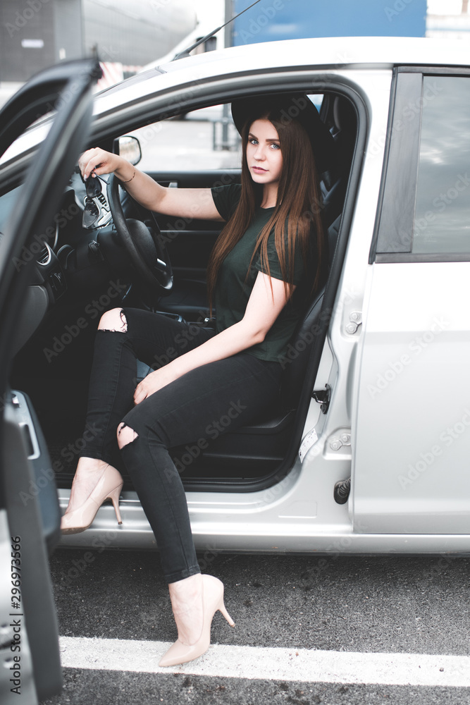 Stylish girl 20-24 year old wearing trendy clothes sitting in car closeup. Stylish girl 20-24 year old wearing trendy clothes sitting in car closeup.