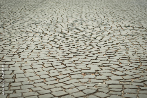 Blank street tile texture. Cobblestone close-up. Sharpness on granite tile. Layout for design. The area is removed from the lower angle.