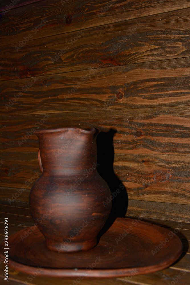 Clay jug in wood tone and wood texture background