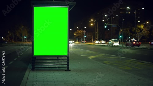 Bus stop advertising billboard green screen at night photo