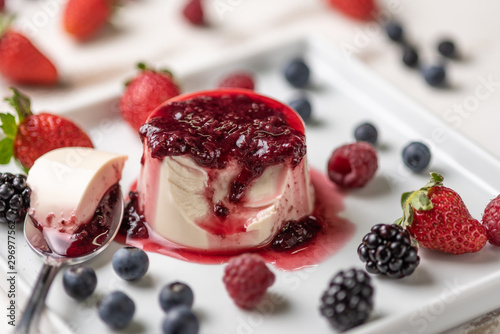 Bild auf Leinwand Delicious italian dessert panna cotta with berry sauce, fresh berries on white w