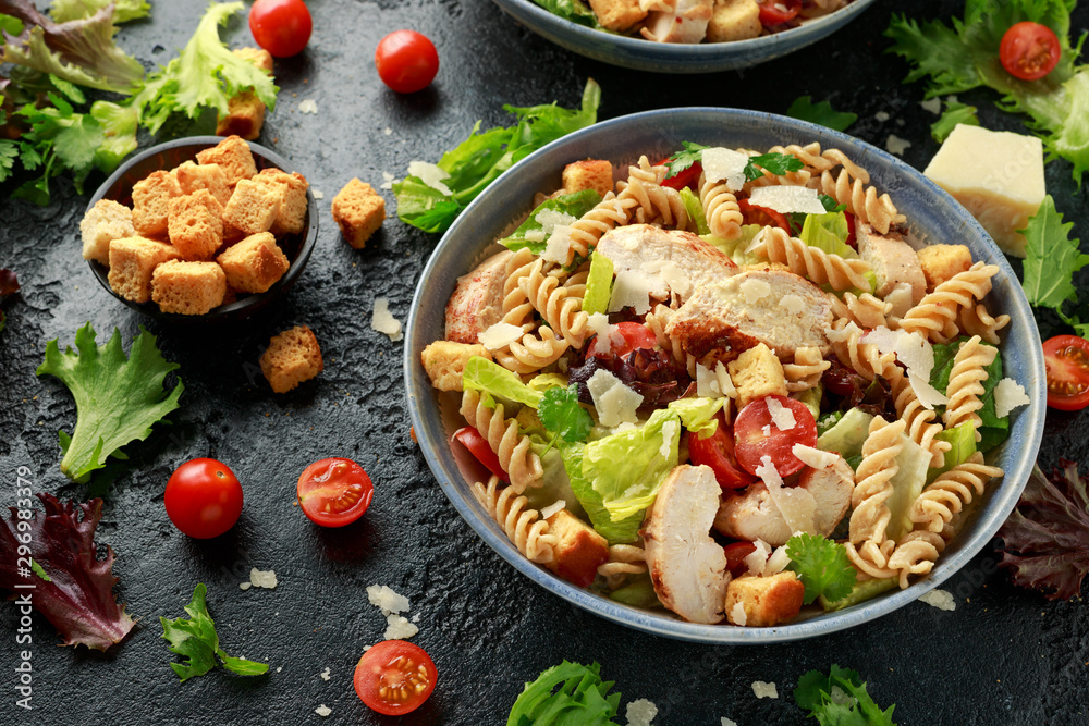 Caesar Salad Pasta with chicken, tomato, parmesan cheese and vegetables