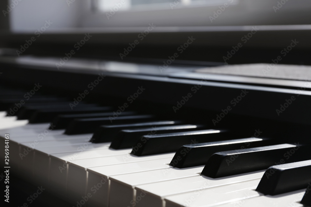 Modern piano with black and white keys indoors, closeup Modern piano with black and white keys indoors, closeup