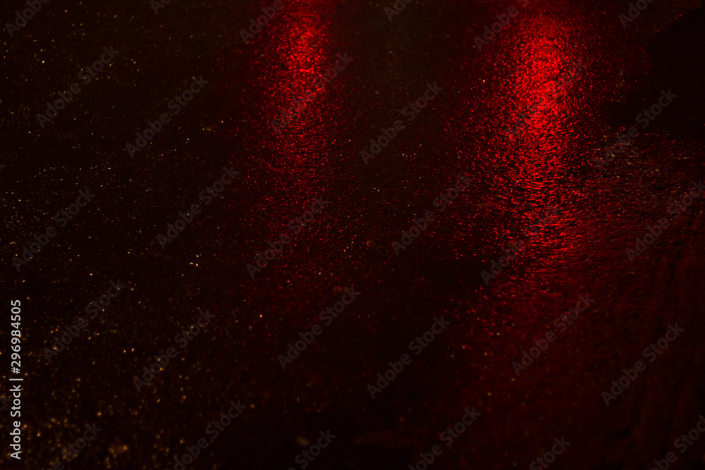 the reflection of headlights on wet asphalt night abstract background