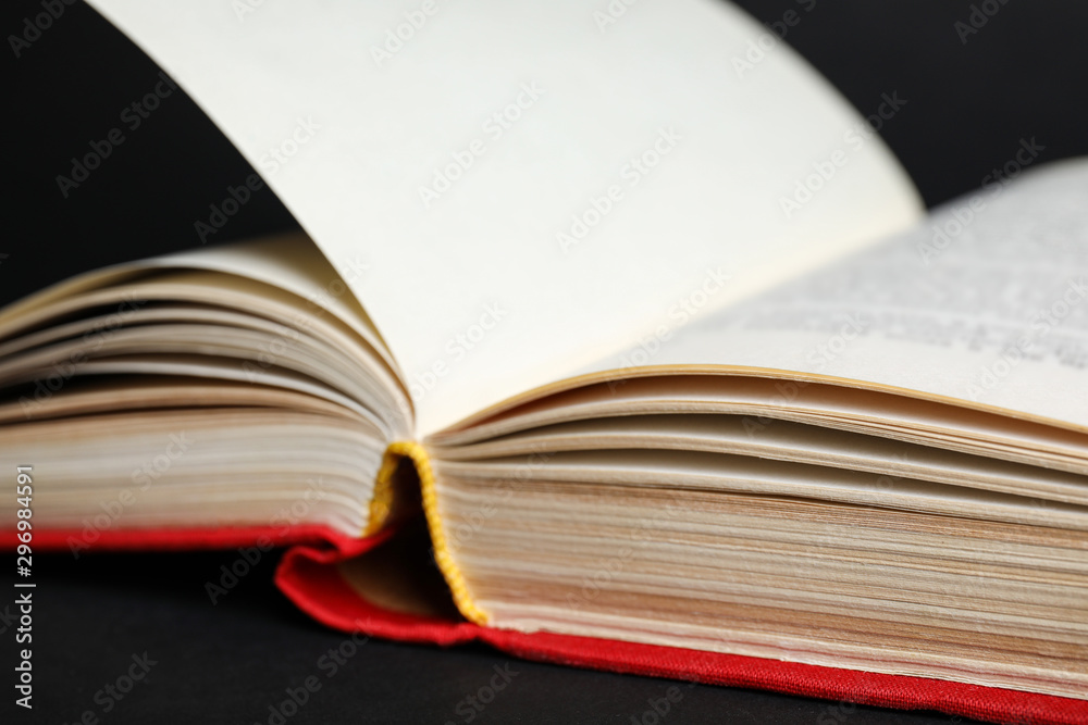 Closeup view of open book on black background Closeup view of open book on black background