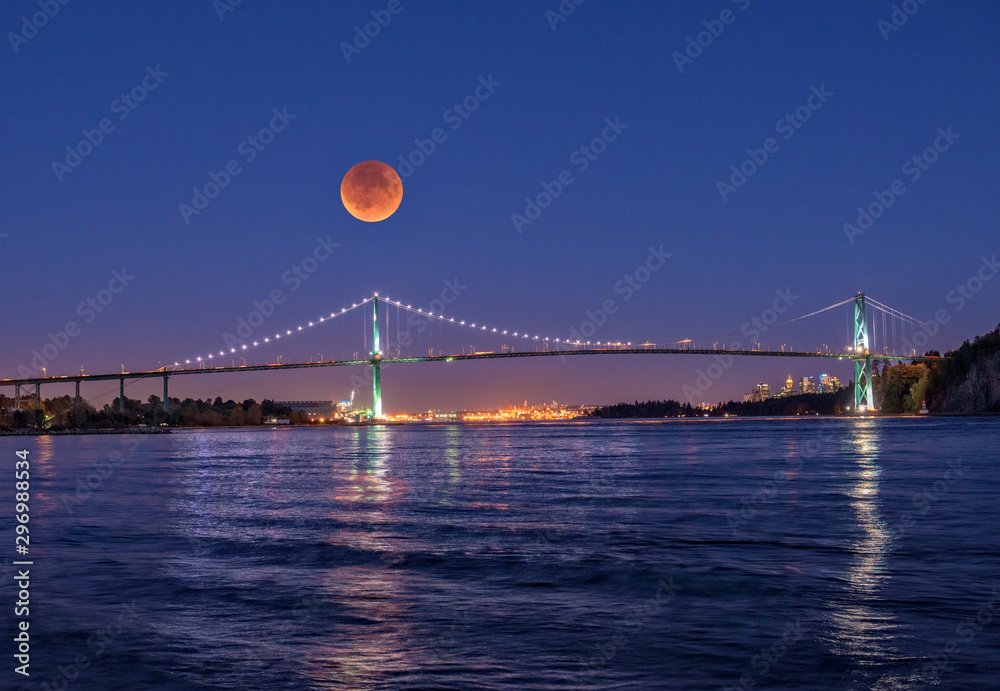 A fool blood moon eclipse rising over the Lions Gate bridge in Vancouver Canada
