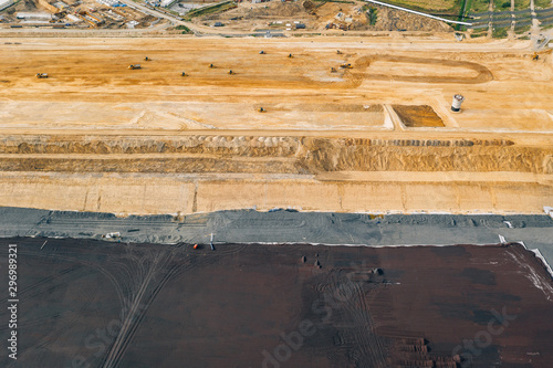 Aerial drone photography of an enormous sand pit construction site. 