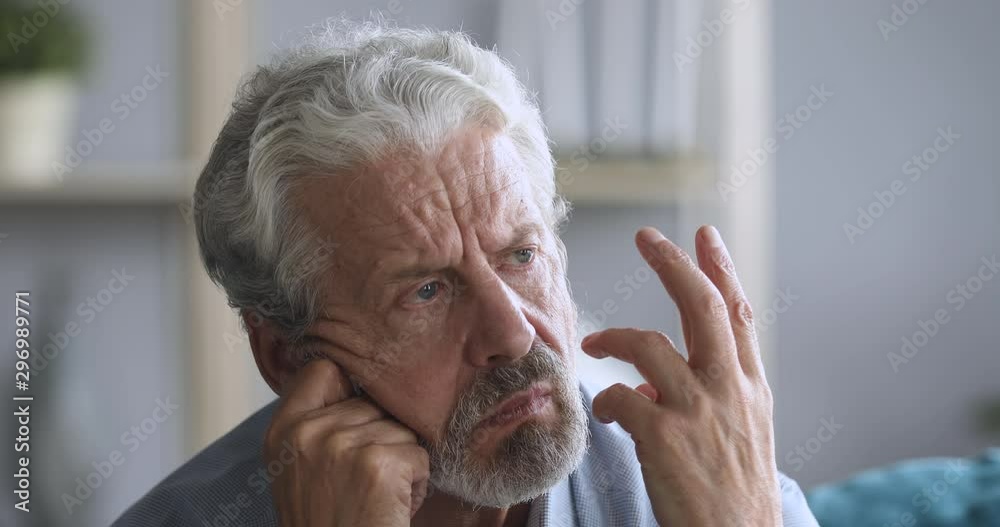 Thoughtful confused senior grandpa feel worried think of memory loss