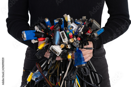 Young woman in black holding a colorful tangle of computer cables with a shallow depth of field