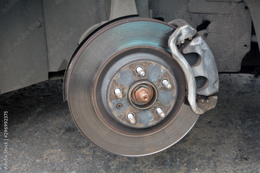 Car without wheels. Disc brake of the car for repair. Worn out brake system.