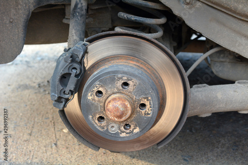 Car without wheels. Disc brake of the car for repair. Worn out brake system.