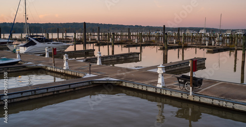 Marina Dock Golden Sunrise with Power Pedestals and Boats on a Still River