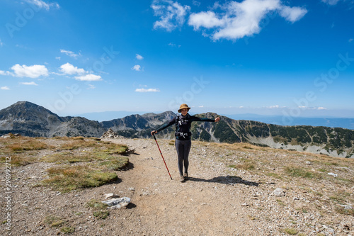 Young woman traveler in the bulgarian mountains , hiking in the sunny day