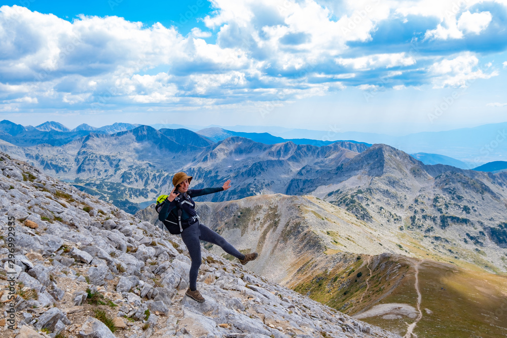 Obraz premium Young woman traveler in the bulgarian mountains , hiking in the sunny day