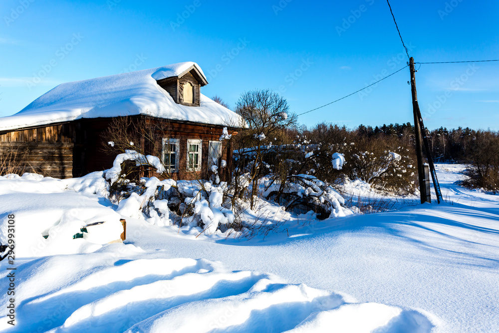 Fototapeta premium Old russian village with wooden houses. Early winter frost morning.