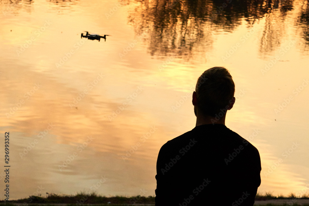 Fototapeta premium man controls the drone. view from the back