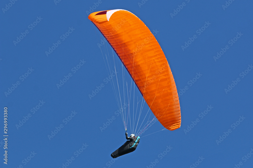 Paraglider flying wing in a blue sky Paraglider flying wing in a blue sky