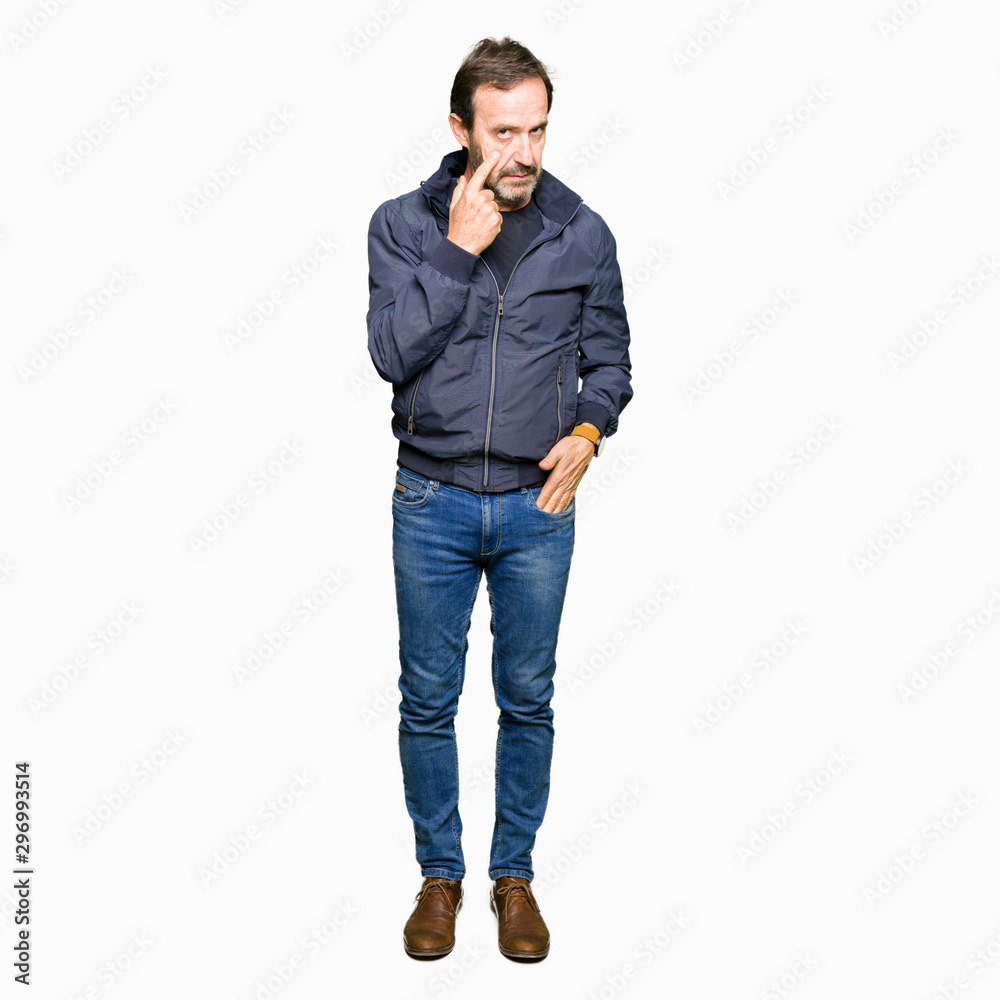 Middle age handsome man wearing a jacket Pointing to the eye watching you gesture, suspicious expression Middle age handsome man wearing a jacket Pointing to the eye watching you gesture, suspicious expression