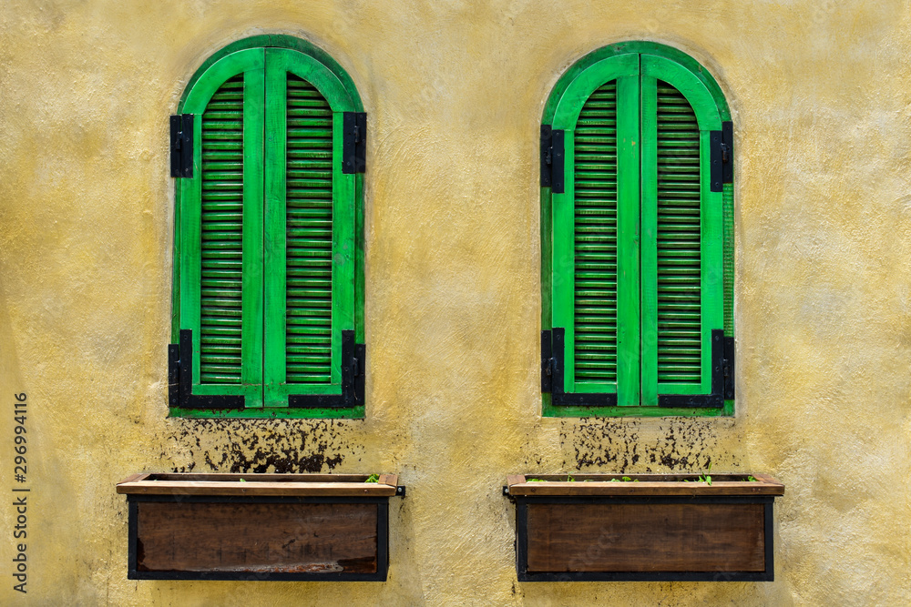 Ventanas rústicas de madera pintada de color verde y pared color amarillo  estilo italiano Stock Photo | Adobe Stock