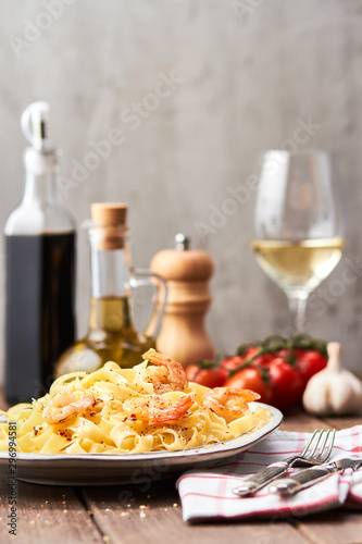 Tasty pasta with olive oil and fried shrimps