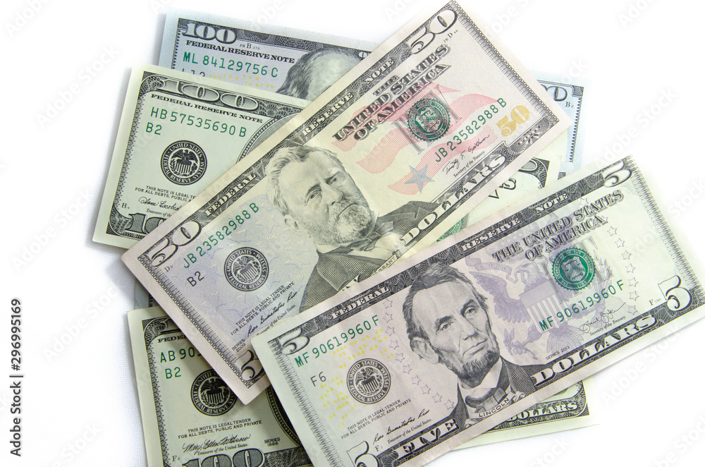 American dollars denominations of one hundred, fifty, five. Arranged in a chaotic manner, a short flight of stairs, a bill on a bill. Old sample and new notes. Dollars in hands are twisted into a tube American dollars denominations of one hundred, fifty, five. Arranged in a chaotic manner, a short flight of stairs, a bill on a bill. Old sample and new notes. Dollars in hands are twisted into a tube