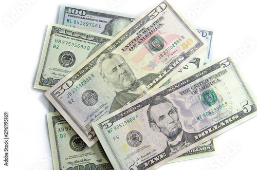 American dollars denominations of one hundred, fifty, five. Arranged in a chaotic manner, a short flight of stairs, a bill on a bill. Old sample and new notes. Dollars in hands are twisted into a tube