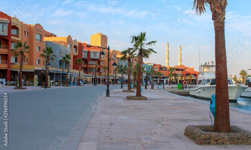 Hurghada, Egypt. Promenade and harbor in the Red Sea. View of embankment with  houses, moored yachts  and  mosque.