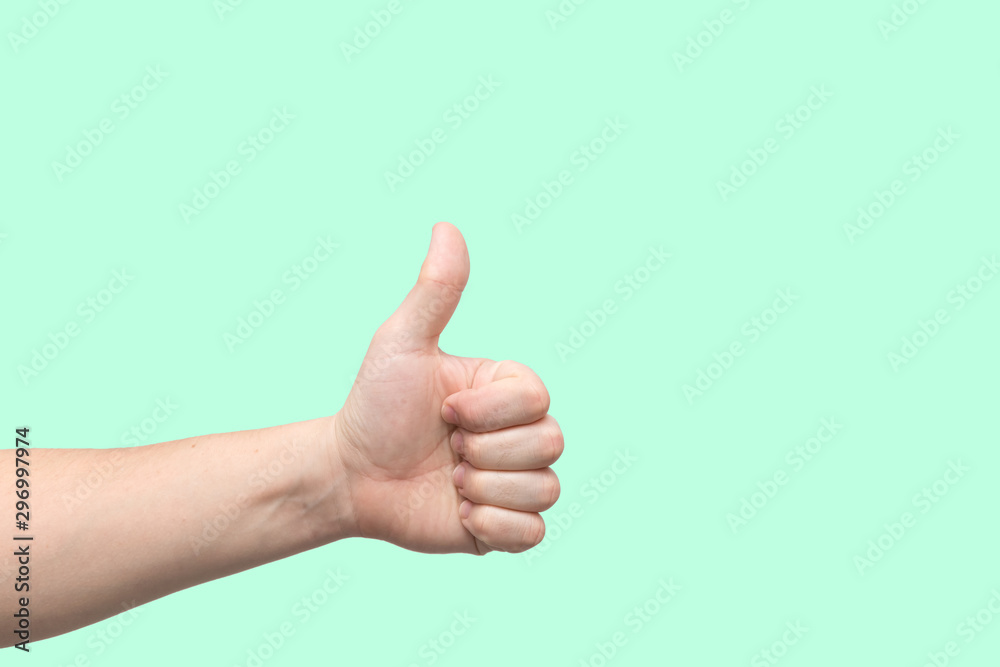 Closeup of male hand showing thumbs up sign