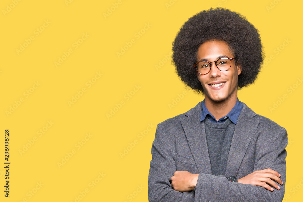 Young african american business man with afro hair wearing glasses happy face smiling with crossed arms looking at the camera. Positive person. Young african american business man with afro hair wearing glasses happy face smiling with crossed arms looking at the camera. Positive person.