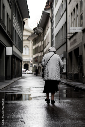 Old woman walks in alley