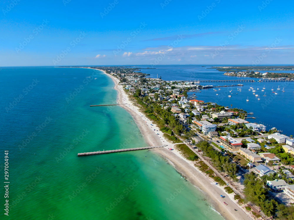 Aerial view of Cortez beach withe sand beach and his little wood pier on blue water, Anna Maria Island, Florida, USA