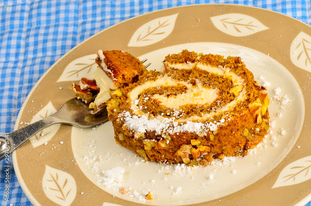 Closeup of Slice of Pumpkin Roll sprinkled with Powdered Sugar Closeup of Slice of Pumpkin Roll sprinkled with Powdered Sugar